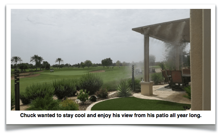 A patio with grass and trees in the background.